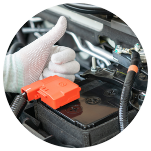 mechanic giving thumbs up next to car battery 